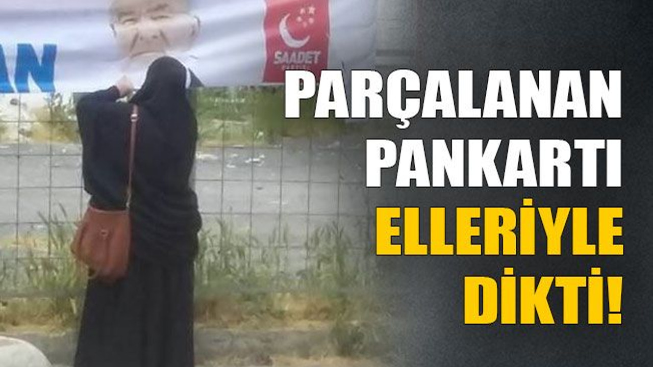 Parçalanan pankartı elleriyle dikti!