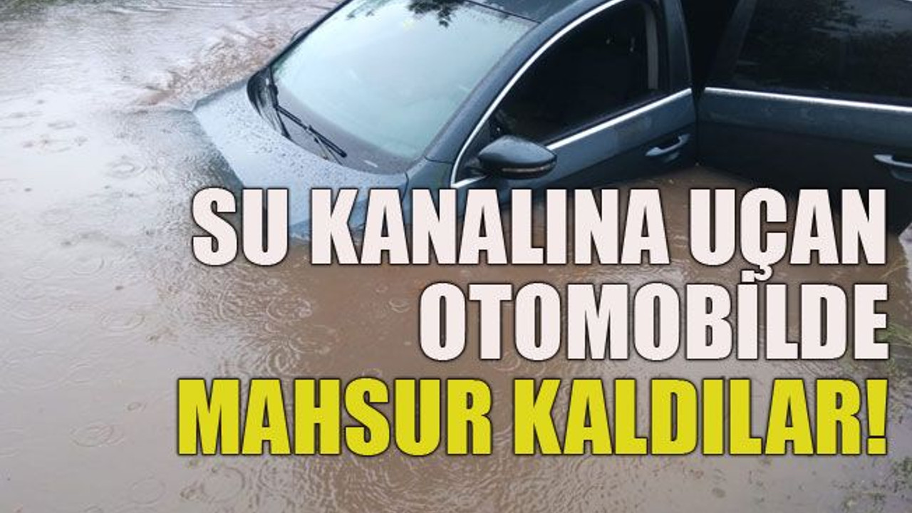 Su kanalına uçan otomobilde mahsur kaldılar!