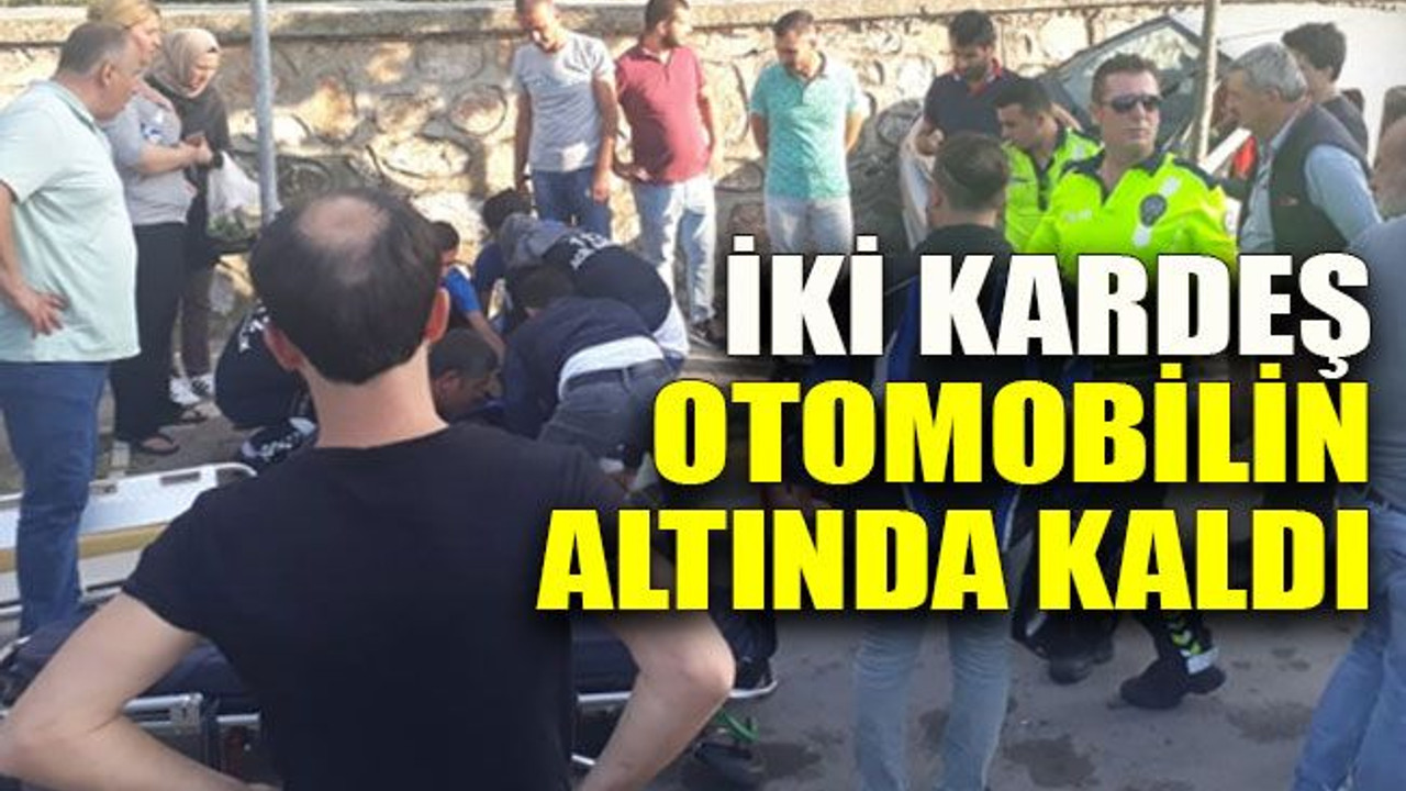 İki kardeş otomobilin altında kaldı