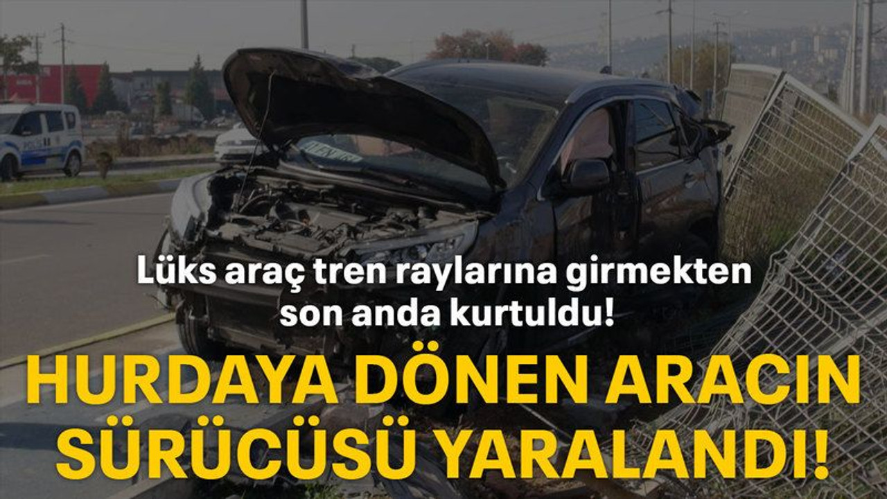 Lüks araç tren raylarına girmekten son anda kurtuldu! Hurdaya dönen aracın sürücüsü yaralandı