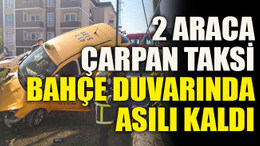 2 araca çarpan taksi bahçe duvarında asılı kaldı
