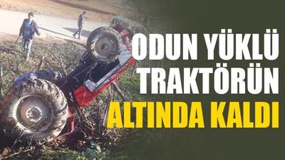 Odun yüklü traktörün altında kaldı